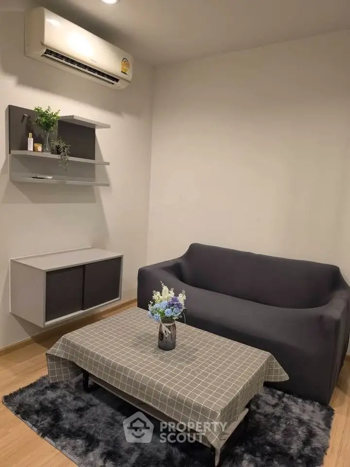 Cozy living room with modern sofa, air conditioning, and stylish decor