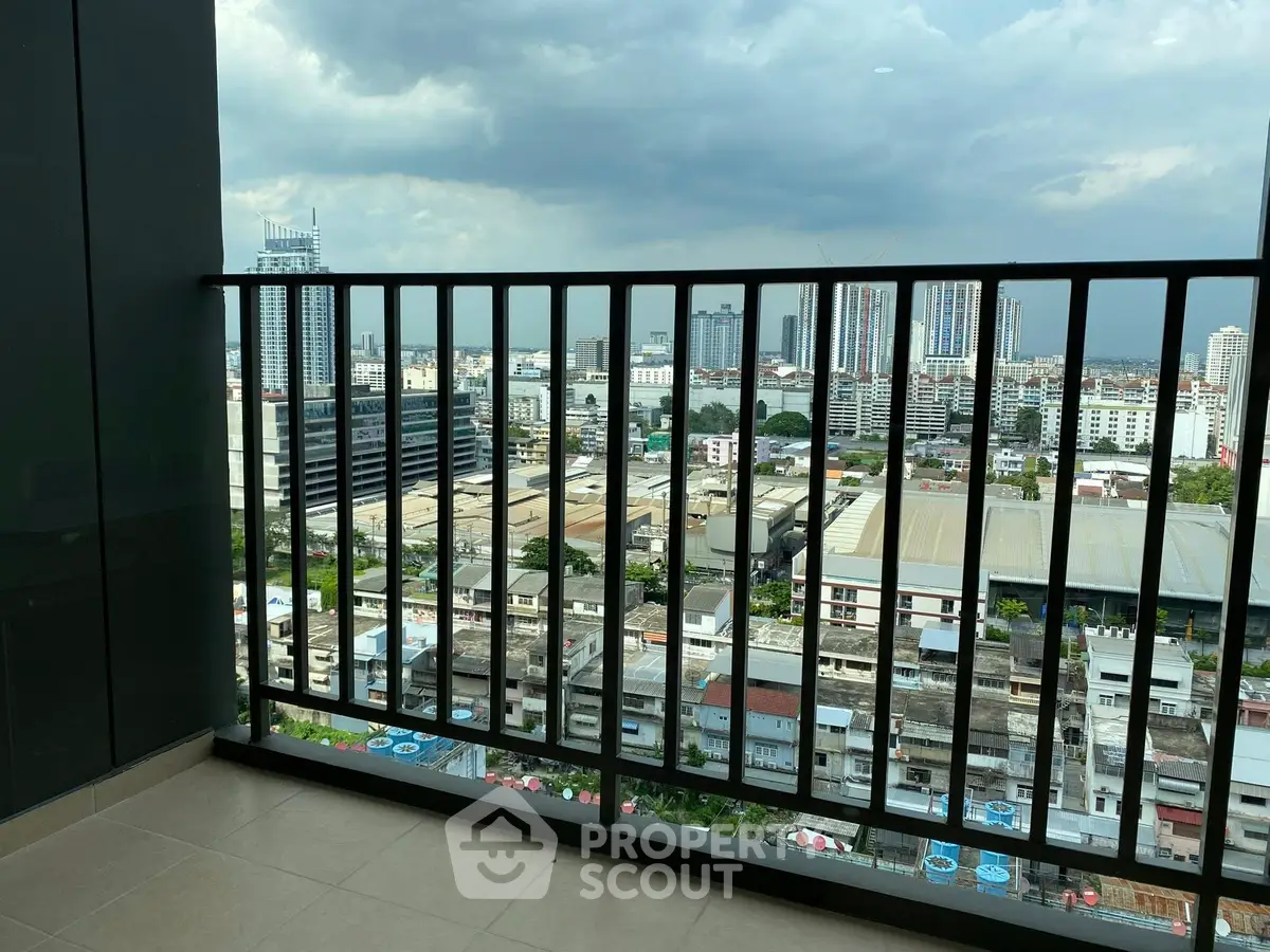Stunning city view from high-rise balcony with sleek railing design.