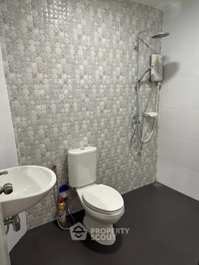 Modern bathroom with stylish tile design and shower setup