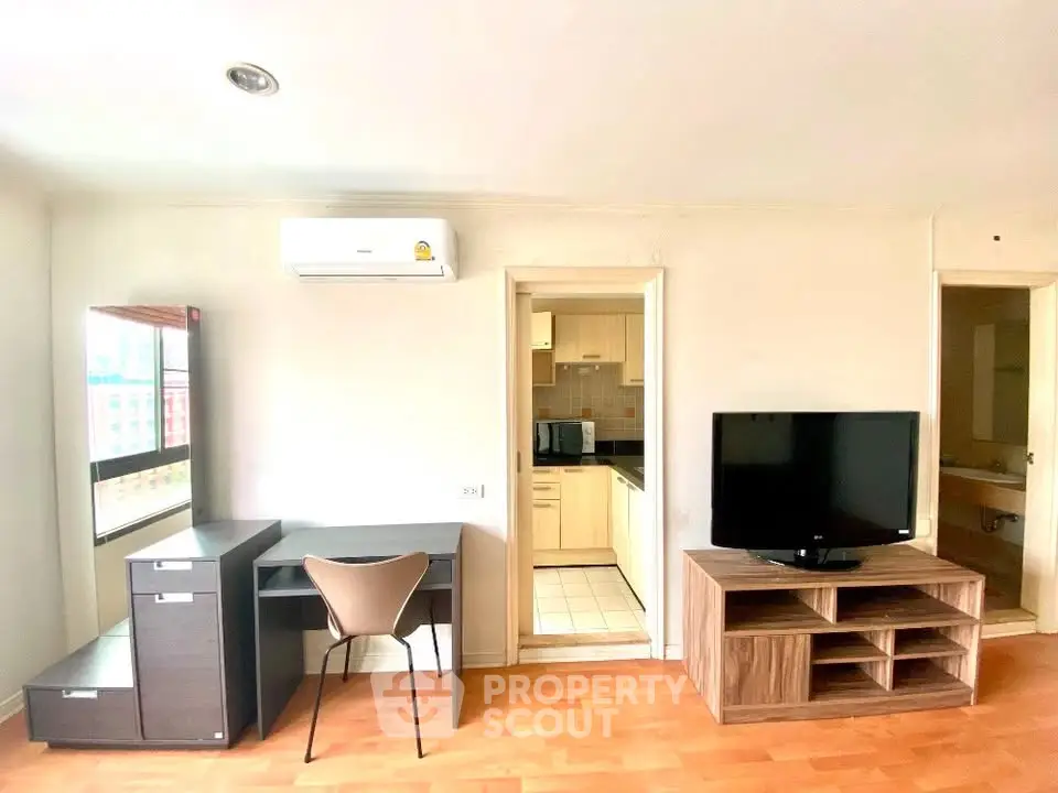 Bright living room with modern furniture and open kitchen layout in a stylish apartment.