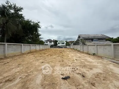 Vacant land plot ready for development in a residential neighborhood.