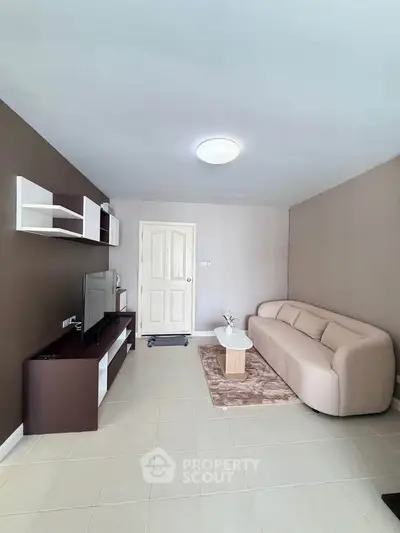Modern living room with sleek furniture and neutral tones, perfect for relaxation and entertainment.