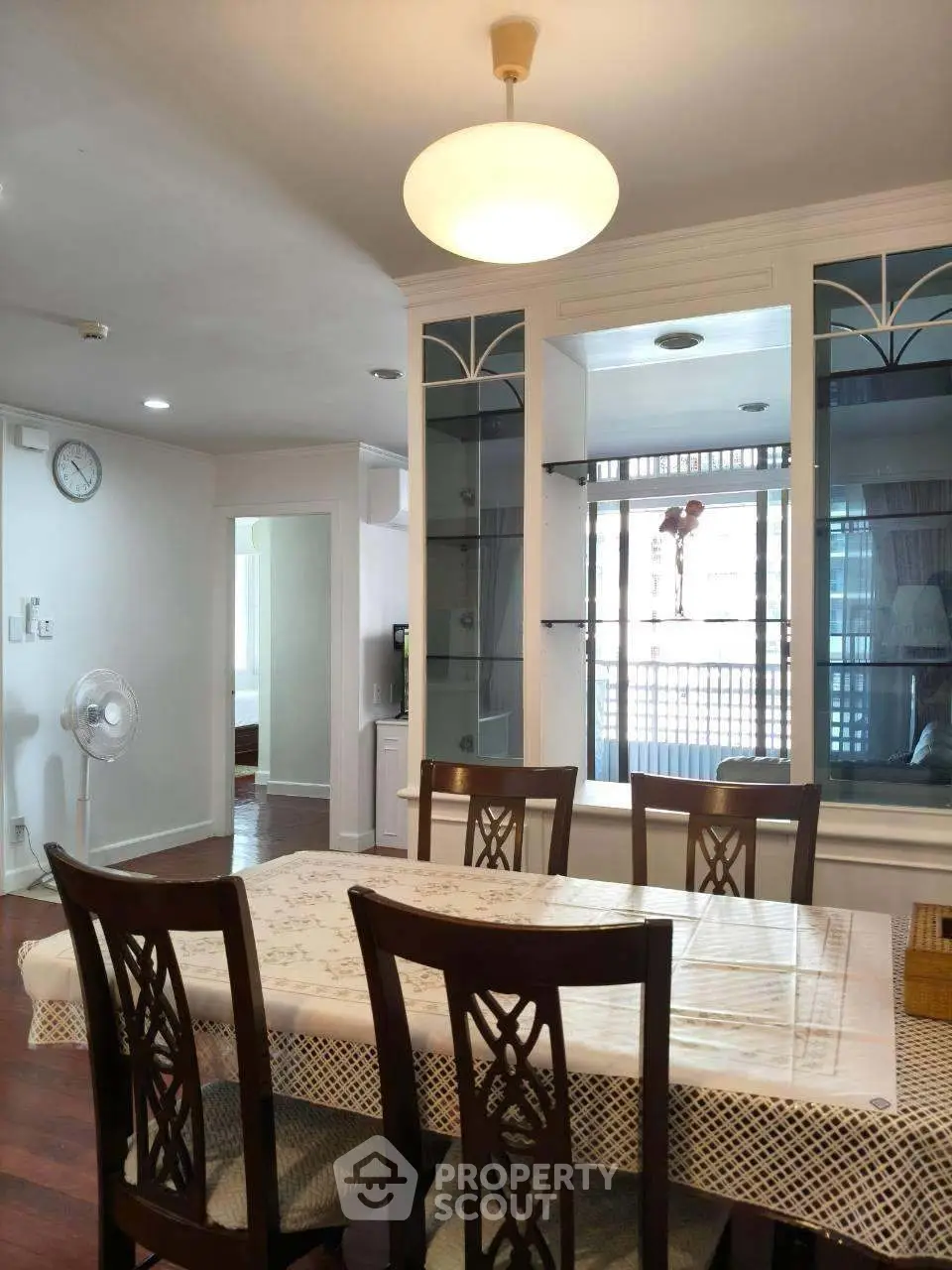 Elegant dining room with wooden furniture and ambient lighting in a modern apartment.