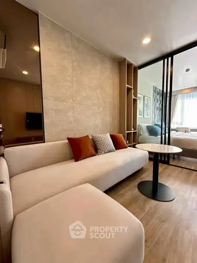 Modern living room with stylish decor and cozy seating in a contemporary apartment.