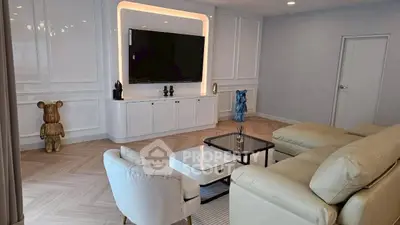 Luxurious modern living room with elegant decor and large TV setup