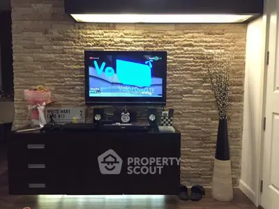 Stylish living room with modern TV setup and elegant decor accents