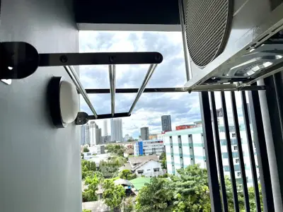 Urban balcony with city view and air conditioning unit, perfect for modern living.