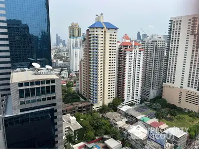 Stunning cityscape view showcasing modern high-rise buildings and lush greenery in a vibrant urban setting.