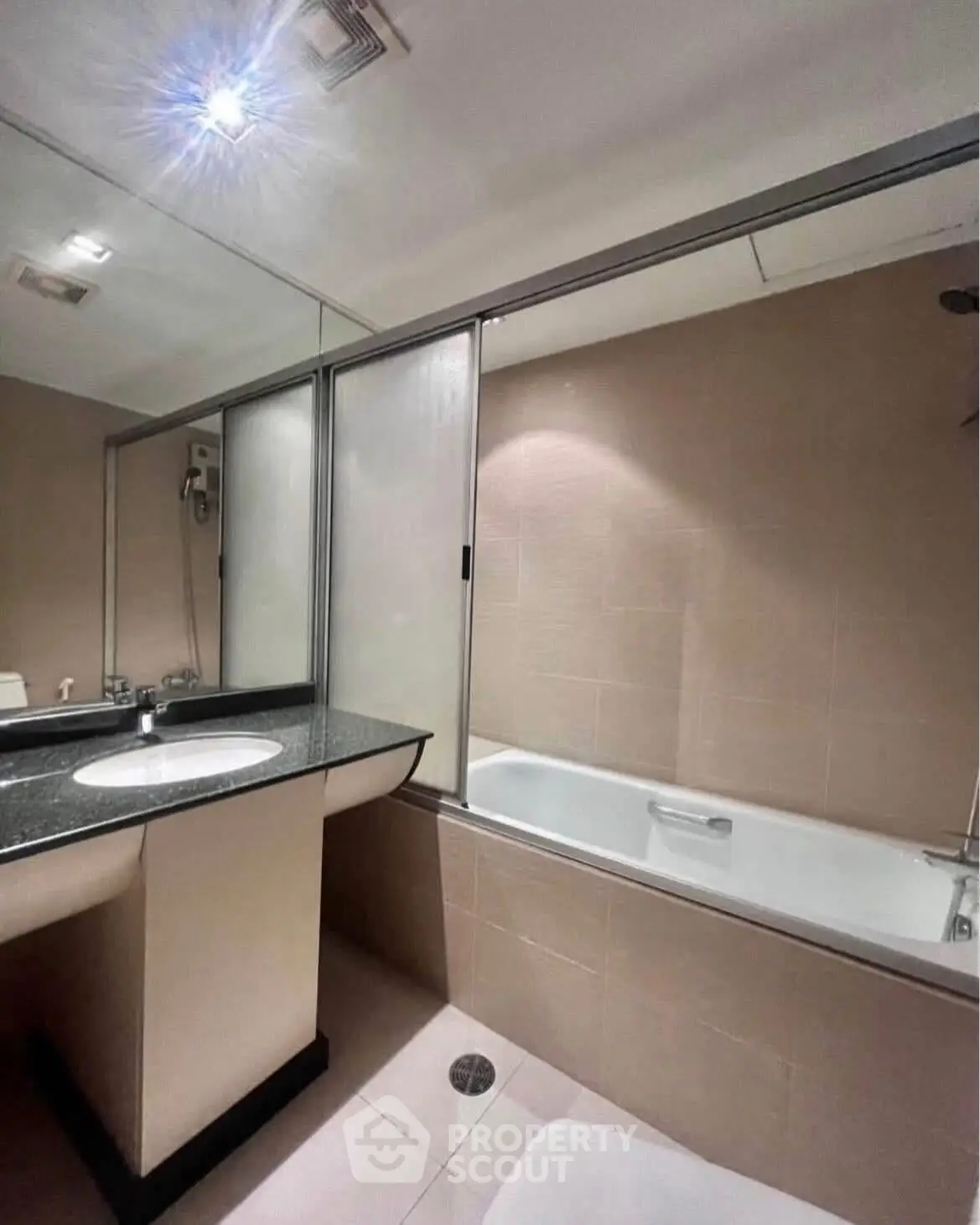 Modern bathroom with sleek design and bathtub in a contemporary apartment.