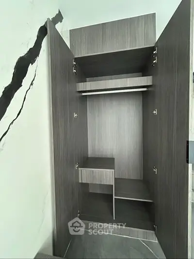 Modern wooden wardrobe with open doors showcasing ample storage space
