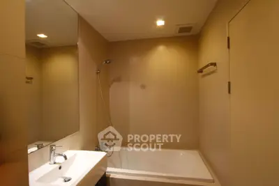 Modern bathroom with sleek design and bathtub in a contemporary apartment.