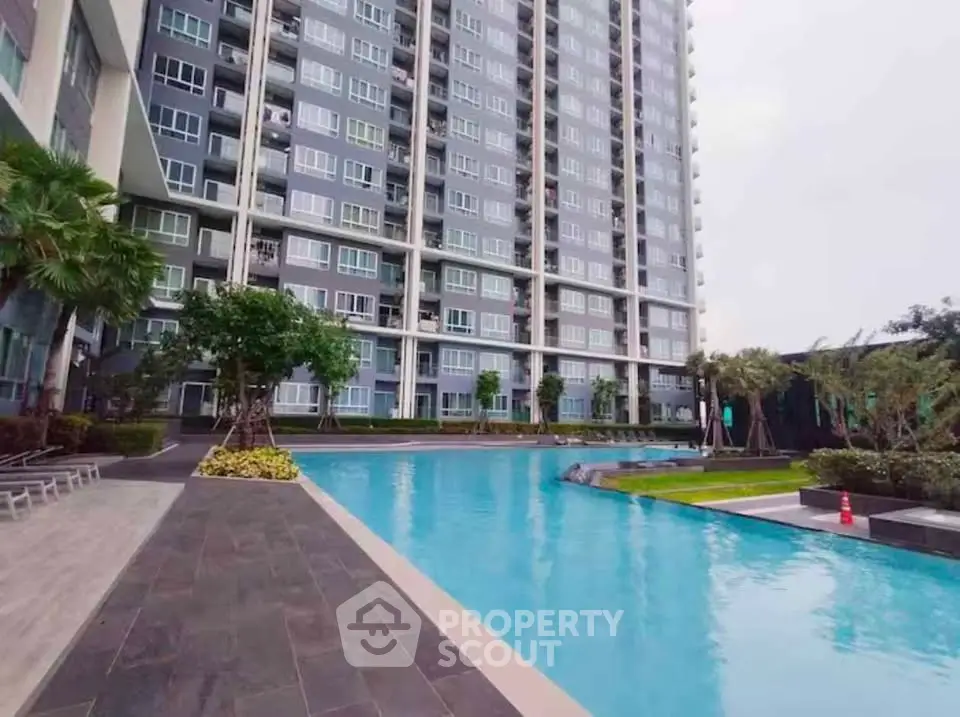 Luxurious high-rise building with stunning pool and landscaped garden