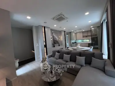 Luxurious modern living room with open kitchen and stylish decor