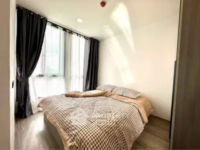 Cozy bedroom with large windows and stylish curtains in modern apartment