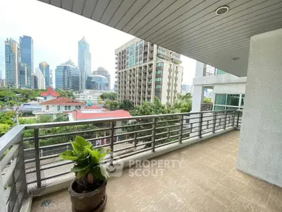 Spacious balcony with city skyline view, perfect for urban living.