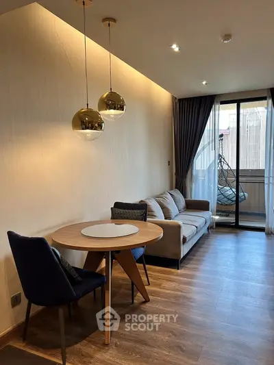 Modern living room with stylish furniture and balcony access in a contemporary apartment.