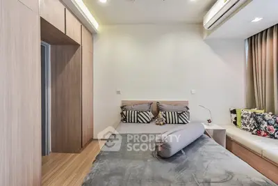 Modern bedroom with stylish decor and cozy seating area