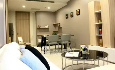 Modern living room with elegant decor and dining area, featuring stylish furniture and ambient lighting.
