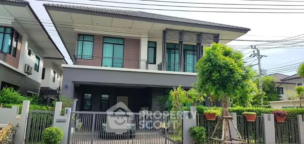Modern two-story house with landscaped garden and secure gated entrance