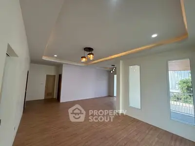 Spacious modern living room with elegant lighting and wooden flooring