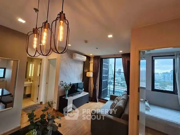 Modern living room with city view, stylish lighting, and cozy furnishings in a high-rise apartment.