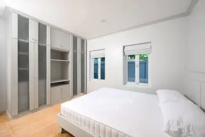 Spacious bedroom with built-in wardrobe and natural light