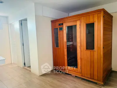 Spacious sauna room in modern real estate property with sleek wooden design.