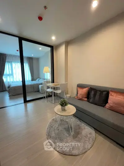 Modern living room with cozy seating and stylish decor in a contemporary apartment.