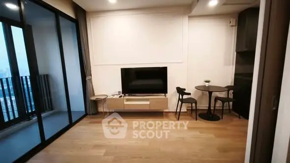 Modern living room with balcony view and stylish furniture in a high-rise apartment.