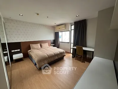 Spacious modern bedroom with large window and stylish decor