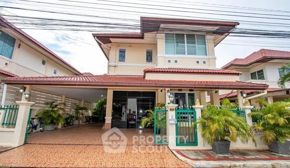 Charming two-story house with red-tiled roof and spacious driveway in a serene neighborhood.
