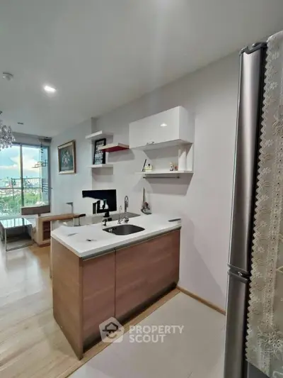 Modern kitchen with sleek cabinetry and open layout in a stylish apartment