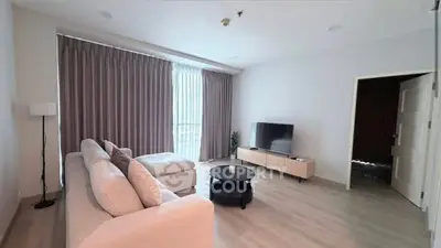 Spacious modern living room with large windows and elegant decor