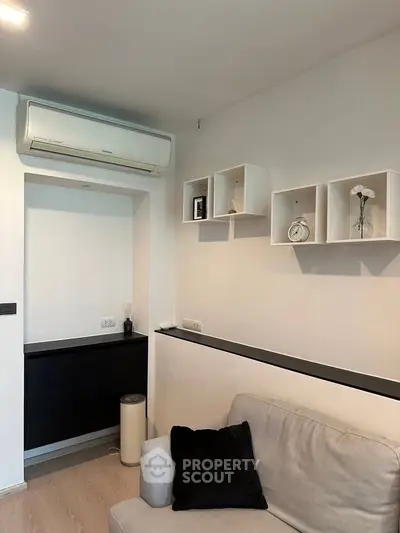 Modern living room with sleek air conditioning and stylish shelving