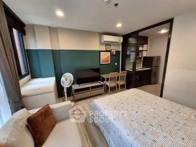 Modern studio apartment with stylish decor and compact kitchen