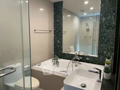 Luxurious modern bathroom with elegant fixtures and a spacious bathtub.