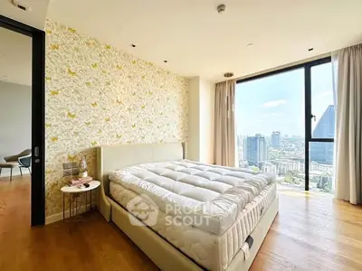 Spacious bedroom with city view, modern decor, and natural light.