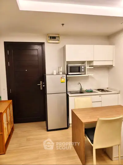 Modern compact kitchen with dining area in a cozy apartment
