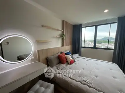 Modern bedroom with large window offering scenic city view, stylish decor, and cozy ambiance.