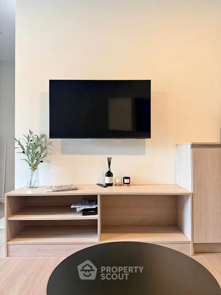 Modern living room with wall-mounted TV and stylish wooden furniture