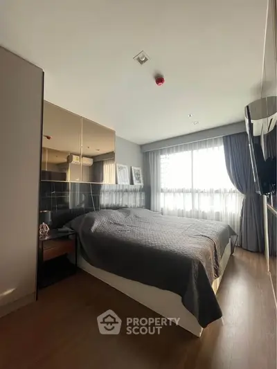 Modern bedroom with large window and stylish decor