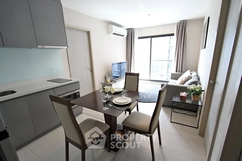 Modern open-plan living room and kitchen with elegant dining area and natural light.