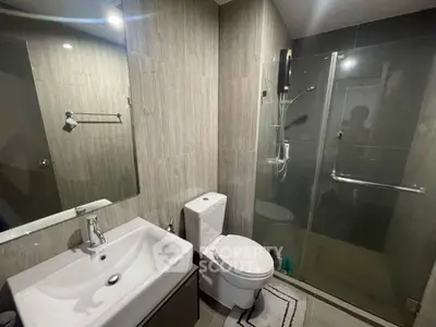 Modern bathroom with glass shower and sleek fixtures in a contemporary apartment.