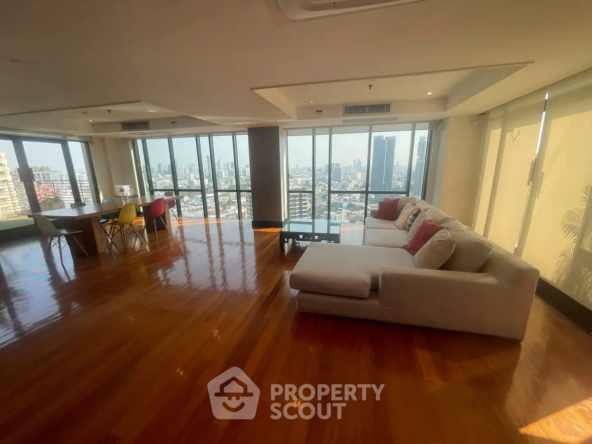 Spacious living room with panoramic city views and modern furnishings