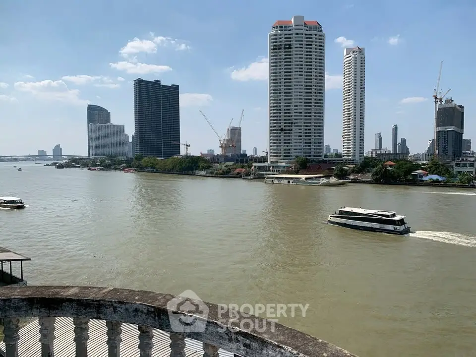 Stunning river view with modern high-rise buildings and boats, perfect for urban living.