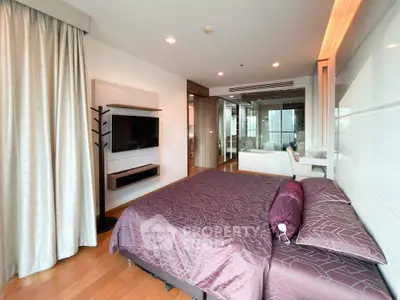 Luxurious bedroom with modern decor and large window offering natural light.