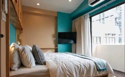 Modern bedroom with large window and stylish decor in urban apartment