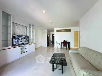 Spacious modern living room with sleek furniture and open layout, perfect for relaxation and entertainment.
