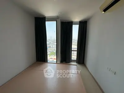 Spacious empty bedroom with large windows and city view