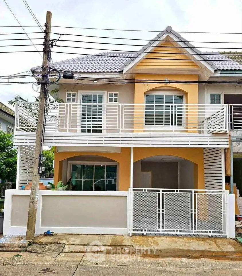 Charming two-story house with modern facade and spacious balcony in a serene neighborhood.